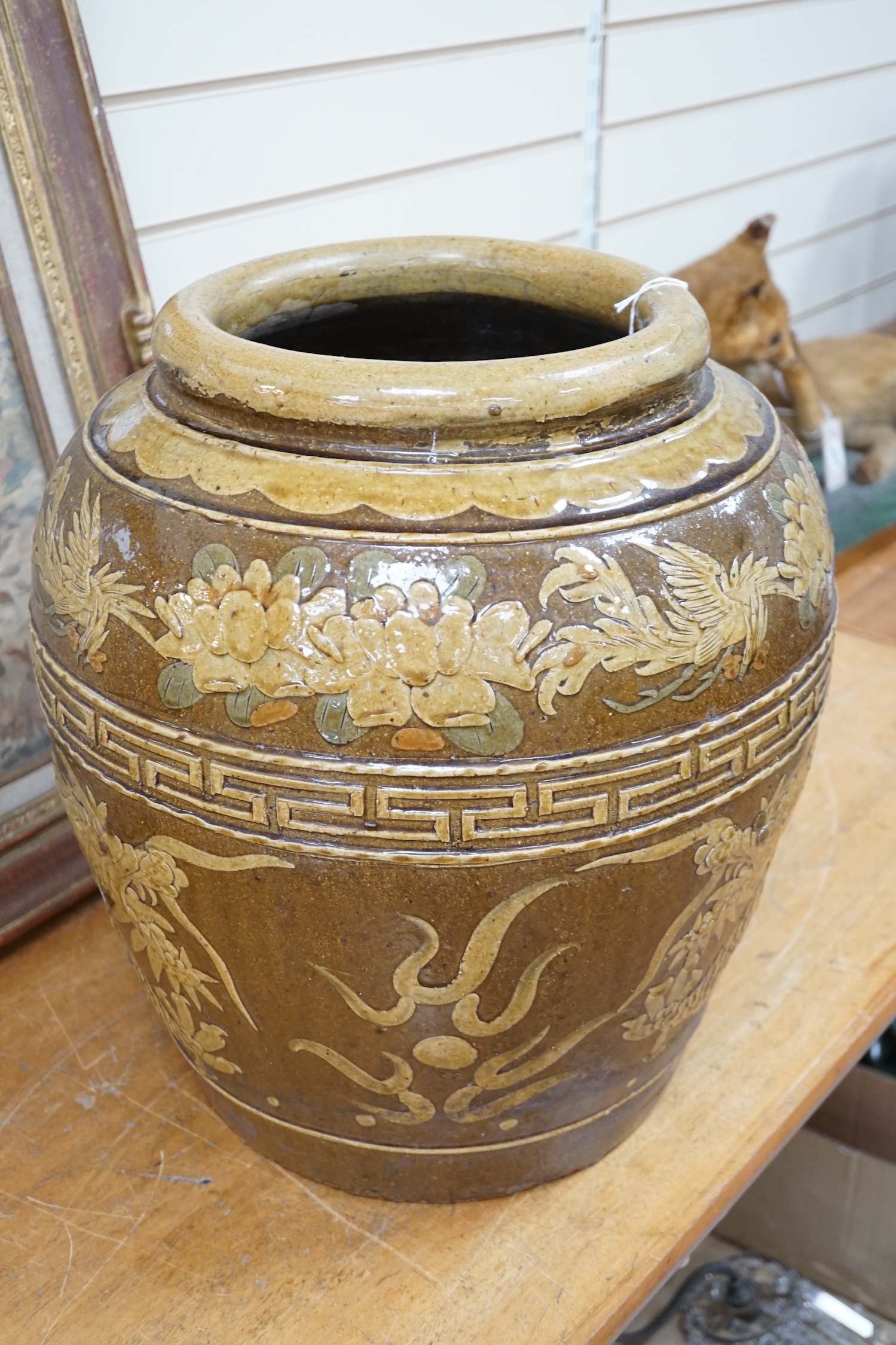 A large Chinese slip decorated ‘dragon and phoenix’ martaban vessel, decorated in relief, 47cm high